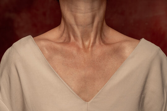 Close-up of Neck and Shoulders Against Red Background