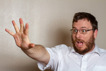 Surprised Man Reaching Out in White Shirt and Glasses