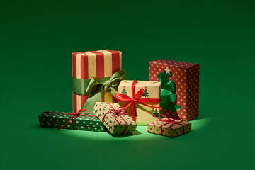 Beautifully Wrapped Christmas Gifts Against Green Background