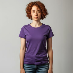 Obraz premium A young Caucasian woman with curly hair stands confidently in a purple t-shirt, presenting a calm and approachable demeanor.