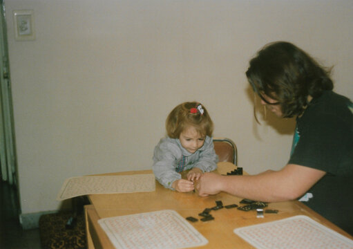 Smiling father and daughter playing game at home