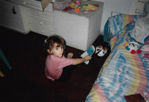 Little girl tying the laces of her sneakers