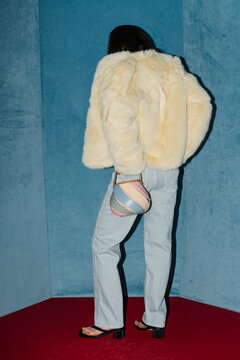 Chic Fashion Model in Fur Coat with Stylish Handbag
