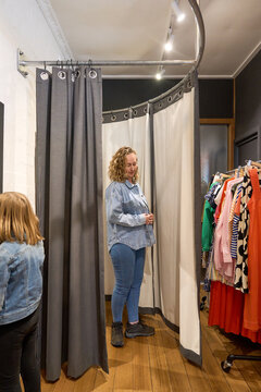 Woman with her daughter in fitting room at boutique shop