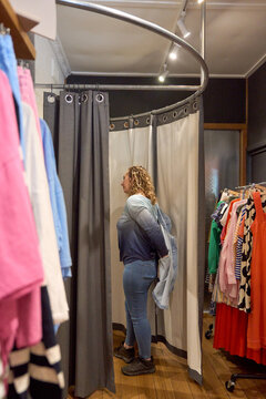 Woman trying on clothes in a fitting room