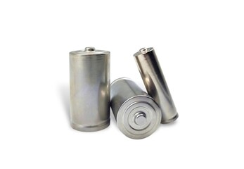 Photo of three silver batteries, isolated on white background.