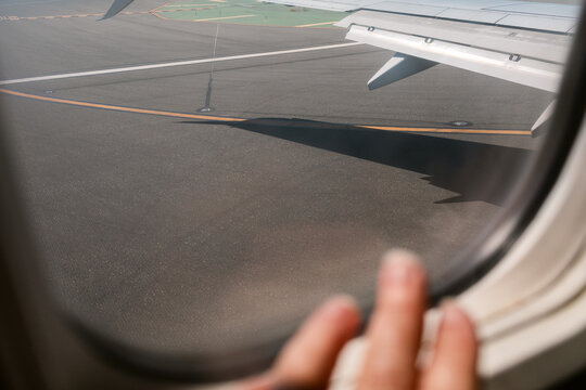 Fototapeta Hand on Airplane Window