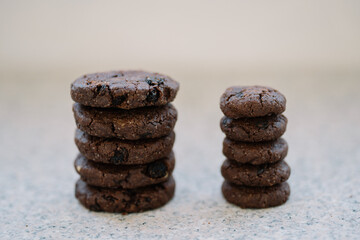 Stack of six chocolate cookies on a granite countertop.