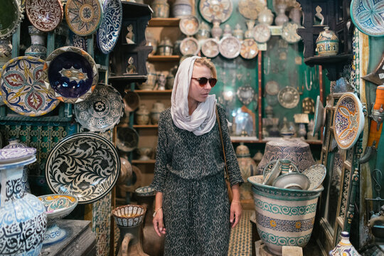 A woman in a traditional Moroccan pottery shop.