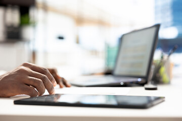HR specialist working on laptop, identifying right candidates for job opening, reviewing resumes to determine candidate qualifications. Close up of headhunter doing screening process