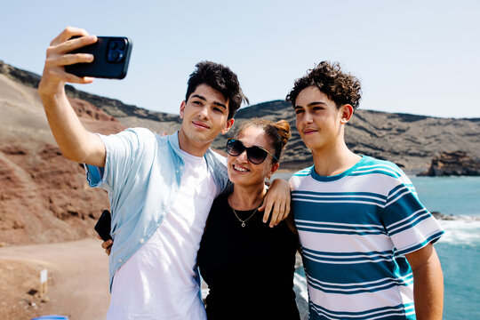 A family take a selfie during a summer vacation in El Golfo, Lanzarote