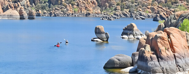 Kayaks on the waters of Watson Lake surrounded by the boulders of Granite Dells - Prescott, AZ.

