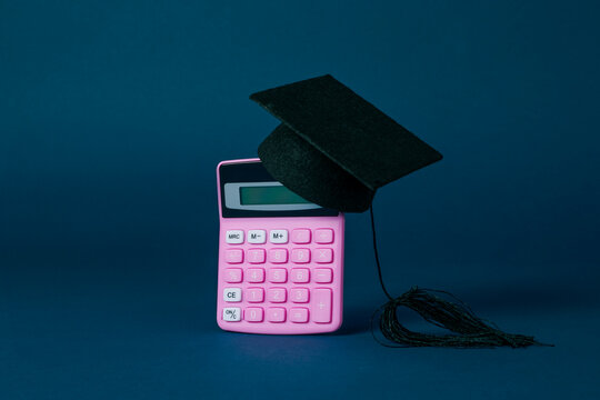 graduate cap on top of a money sack