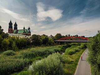 Naklejka premium Poznan Cathedral and cyclist near Cybina River