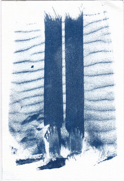 Cyanotype of bare feet on textured sand