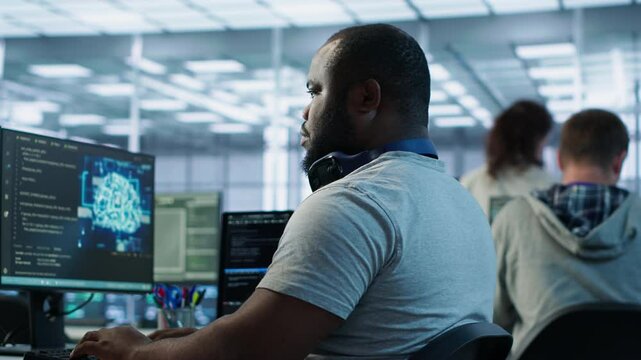 Happy engineer laughing at coworker joke while working in high tech AI facility. Jolly man amused by funny joke said by colleague in artificial intelligence data center, camera A