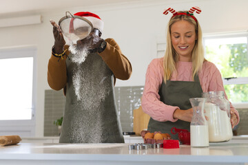 Christmas time, baking together, multiracial couple preparing holiday treats, at home