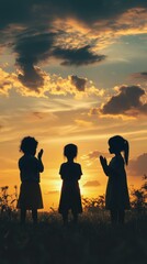 Silhouette of Three Children at Sunset Against Dramatic Sky