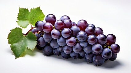 A bunch of ripe purple grapes with green leaves on a light background.