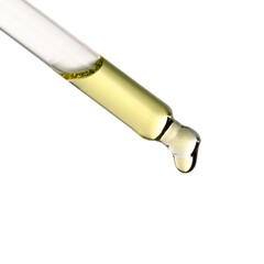 Essential oil dripping from pipette against white background