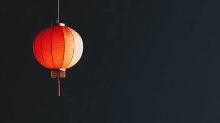 Obraz premium Red, white lantern hanging from ceiling, casting warm glow, creating cozy ambiance in dimly lit room.