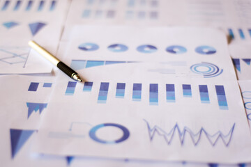 Close up paperwork with printed statistic chart. Financial, account, statistics and business data concept.