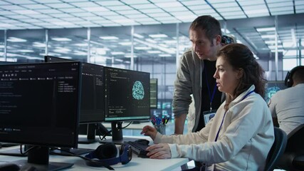 Woman requesting help from senior engineer to fix error in high tech AI data center. Employee in need of aid from IT professional to repair artificial intelligence supercomputers, camera B - Powered by Adobe