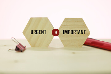 Wood block with the words Urgent vs Important. which isolation concept is more important and...