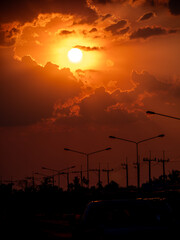 Yellow Sunset in The Red Sky near The Lights from Silhouette Electric Poles