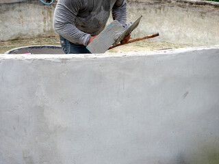 Worker was Plastering The Wall of The Well