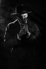 Dark noir portrait of a male detective lighting a cigarette. Private detective, spy, investigation concept.