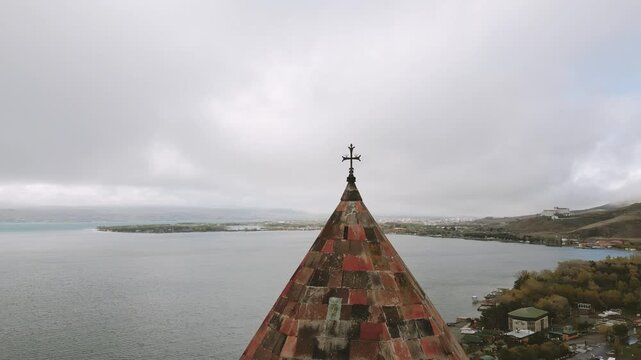 Aerial view cross and cupola over Sevanavank monastic complex. Peninsula at the northwestern shore of Lake Sevan in the Gegharkunik Province of Armenia. Popular travel sightseeing attraction