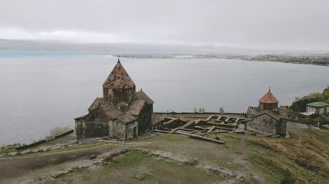 Aerial panning view Sevanavank monastic complex. Peninsula at the northwestern shore of Lake Sevan in the Gegharkunik Province of Armenia. Popular travel sightseeing attraction