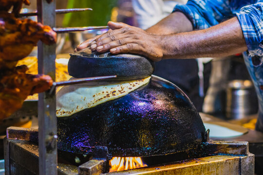 Ulta tawa Paratha being cooked in the streets of Lucknow. It is iconic dish which is fried flatbread on inverted tawa or kadhai.