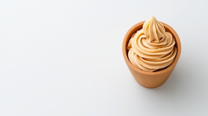 Creamy Caramel Dessert Swirl in Wooden Bowl on White Background