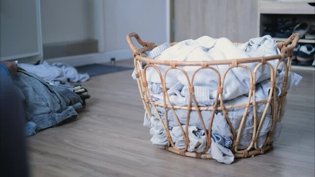 A wicker laundry basket gradually fills with clothes, capturing a cozy weekend chore. This stop-motion video of laundry day, blending simplicity with vintage style. Stop-motion video 4k.
