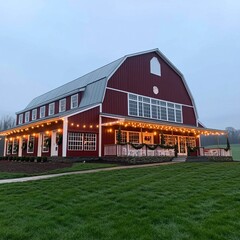 Obraz premium Red barn with white trim and string lights on the porch.