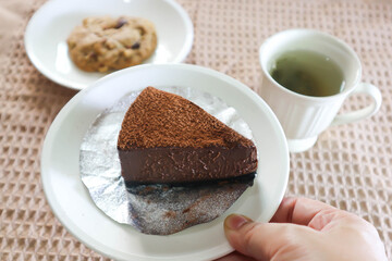 chocolate cake , hot tea and cookie