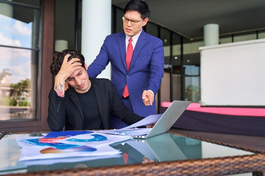 Businessman sad and disapoint from result and blaim from manager in navy blue suit at co working space.