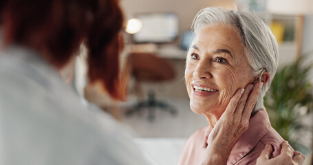 Doctor, senior woman and hearing aid in clinic for geriatric support, tinnitus and help for sound...