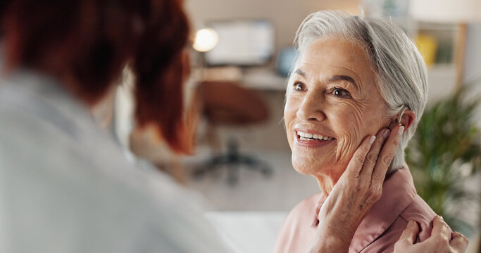 Doctor, senior woman and hearing aid in clinic for geriatric support, tinnitus and help for sound waves. Ent, otolaryngology and patient with cochlear implant for audio, healthcare and auditory tech