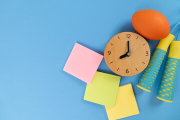Time for exercising clock and exercise equipment with blue background, sport and healthy concept