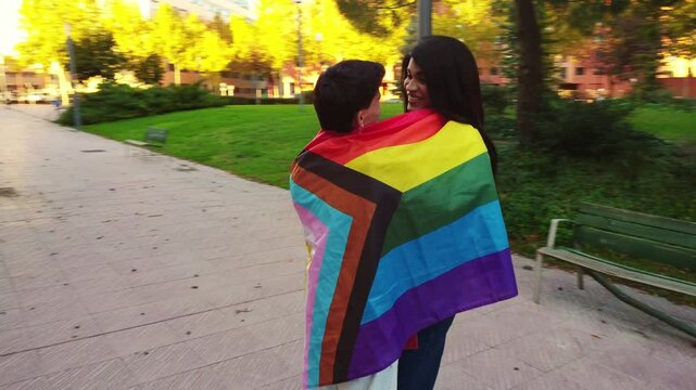 Interracial couple embracing with pride flag