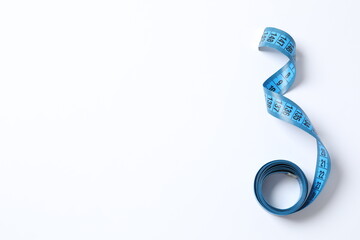 Blue tape measure on a white background, top view
