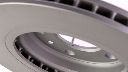 A close up of a wheel with a hole in the center. The wheel is silver and has a shiny finish