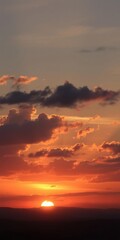Fototapeta premium A breathtaking sunset with clouds casting a warm glow over the evening sky, natural, peaceful, sky