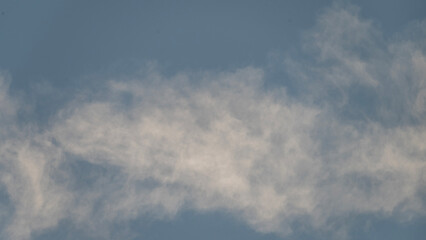 Sky with thin white clouds. Thin whiskey-colored clouds in a blue sky, a view of a sunny blue sky with thin white clouds, an image of a blue sky with thin white clouds.