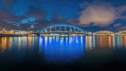 Obraz premium Panorama of the cable stayed bridge of the high-speed road and the football stadium with blue illumination at night