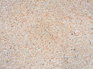 The background image of the wall covered with pebbles and sand looks beautiful and natural.