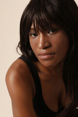 Obraz premium Portrait of beautiful young woman with long hair posing indoor. Vertical.